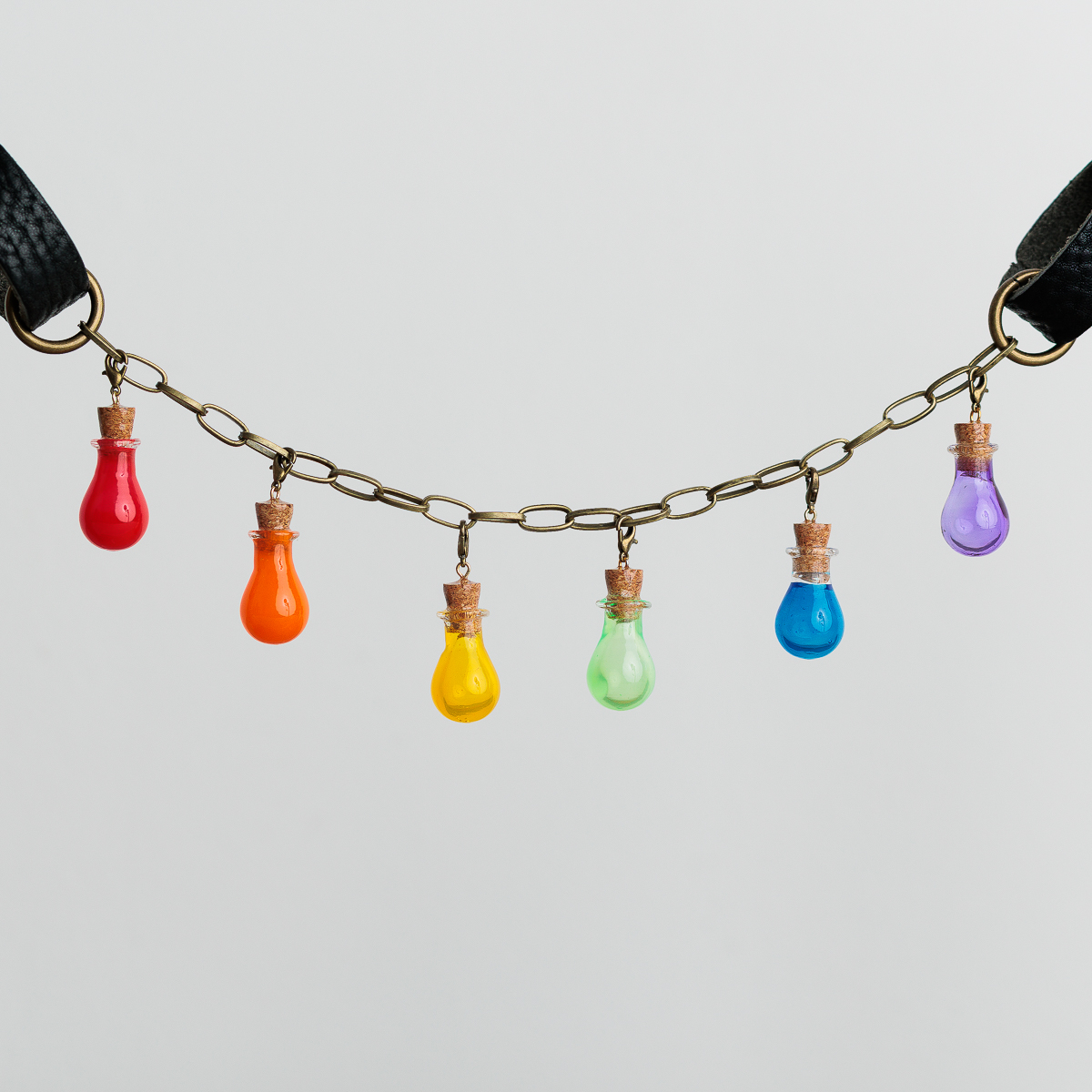 Rainbow assortment of bulb shaped bottles on a belt chain for Renaissance faire outfit